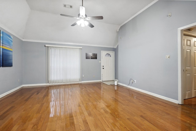 empty room featuring crown molding, ceiling fan, vaulted ceiling, and light hardwood / wood-style floors