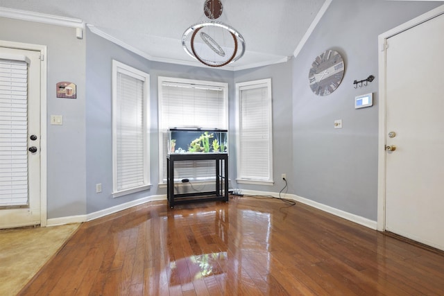 entrance foyer featuring crown molding and hardwood / wood-style floors