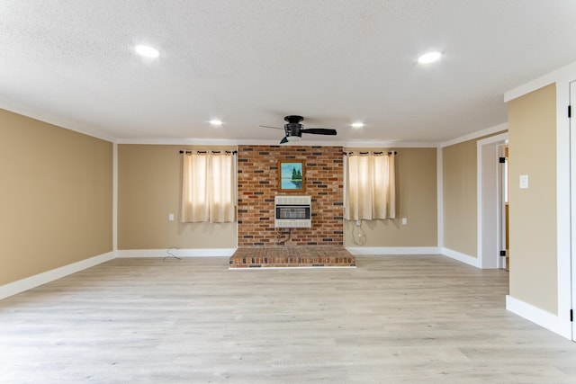 unfurnished living room with heating unit, a textured ceiling, ornamental molding, ceiling fan, and light hardwood / wood-style floors