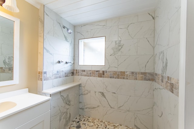 bathroom featuring vanity and a tile shower