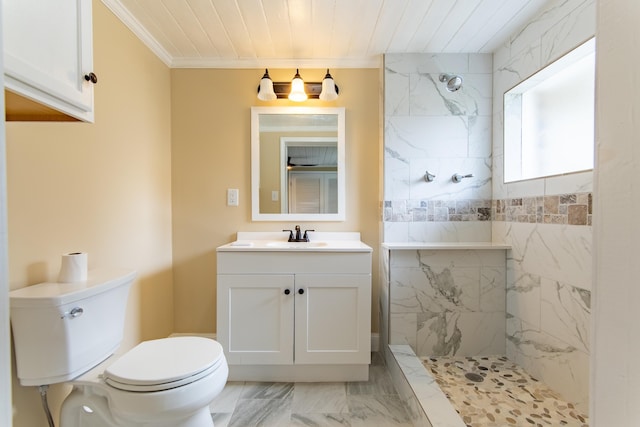 bathroom with crown molding, vanity, toilet, and a tile shower