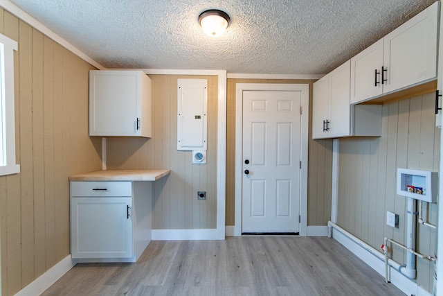 laundry area with cabinets, light hardwood / wood-style flooring, electric panel, washer hookup, and hookup for an electric dryer