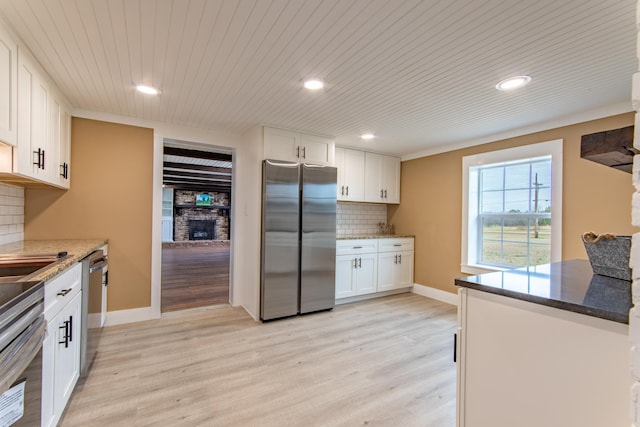 kitchen featuring white cabinetry, appliances with stainless steel finishes, and light hardwood / wood-style flooring