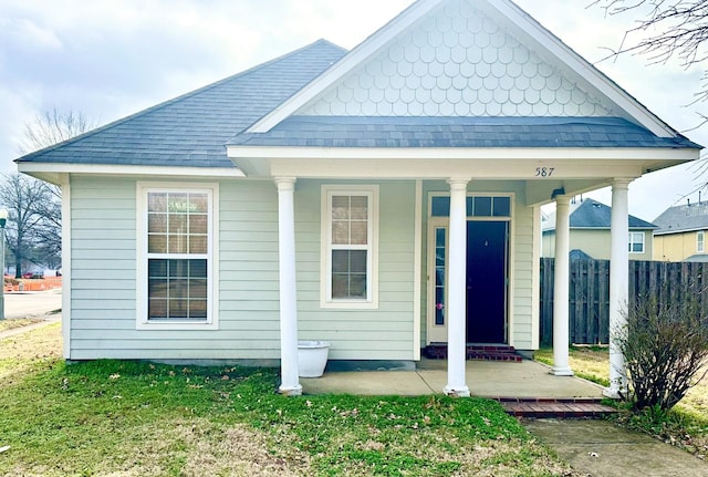 view of front of house with a front yard and a porch