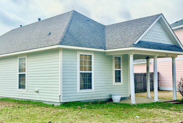 rear view of property featuring a yard