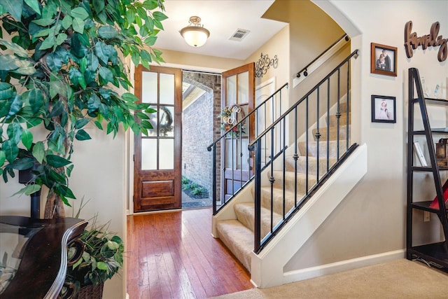 foyer entrance with hardwood / wood-style flooring