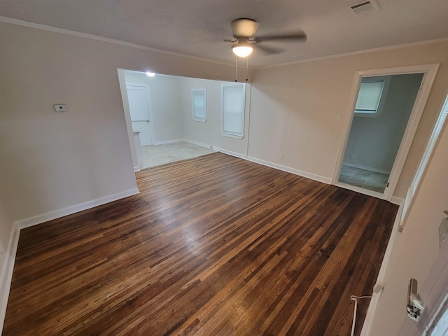 empty room with crown molding, ceiling fan, and dark wood-type flooring