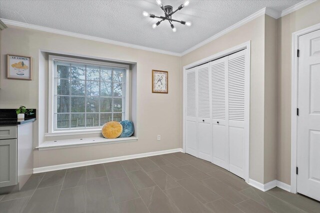 6961 Wittenham Cv, Memphis, TN 38119 - unfurnished bedroom with ornamental molding, a notable chandelier, a textured ceiling, and a closet