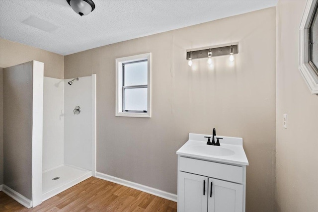 6961 Wittenham Cv, Memphis, TN 38119 - bathroom featuring hardwood / wood-style flooring, vanity, a textured ceiling, and a shower