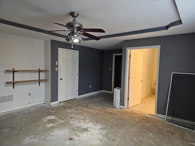 unfurnished bedroom featuring ceiling fan and ensuite bath