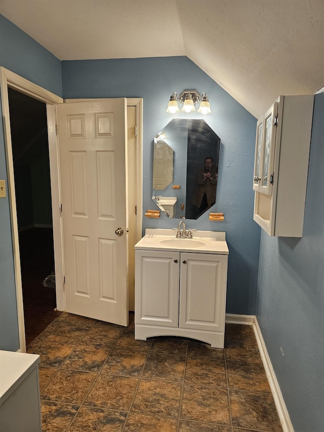 bathroom featuring vanity and vaulted ceiling