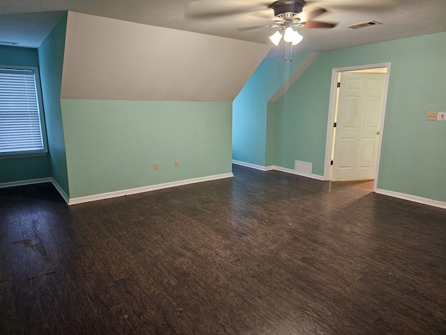 bonus room with ceiling fan, dark hardwood / wood-style flooring, and vaulted ceiling