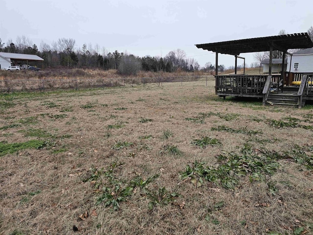 view of yard with a wooden deck and a pergola