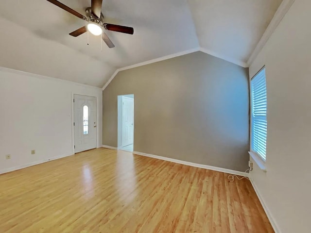 interior space featuring vaulted ceiling, ornamental molding, ceiling fan, and light hardwood / wood-style floors