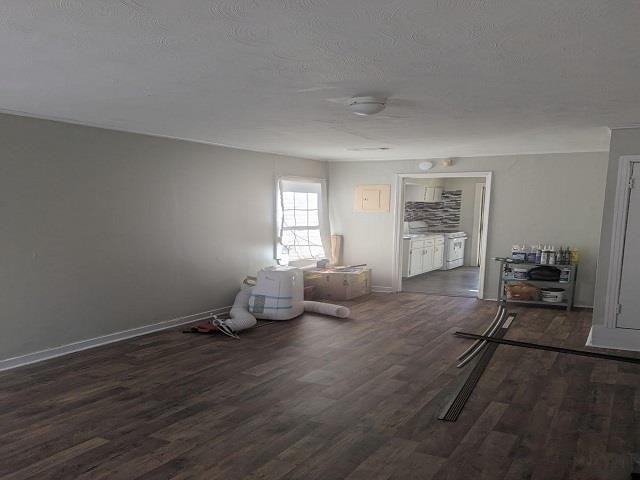 interior space with dark hardwood / wood-style flooring and a textured ceiling