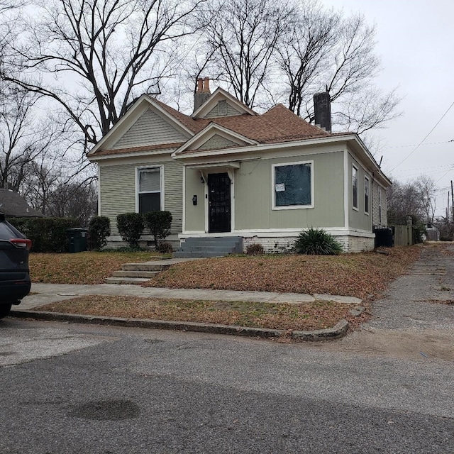 bungalow with central air condition unit and a chimney