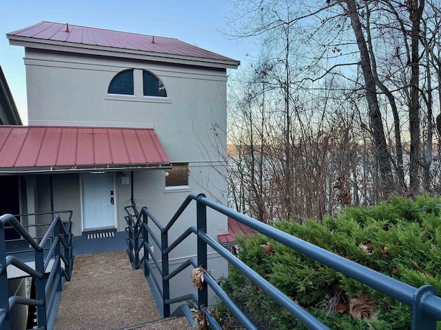 back of property featuring a balcony