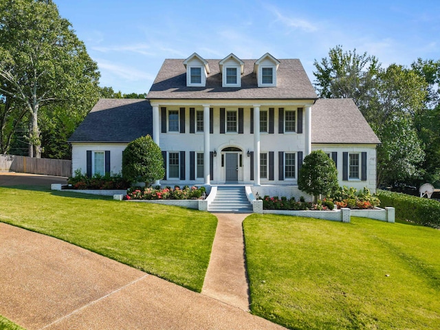 colonial-style house with a front yard