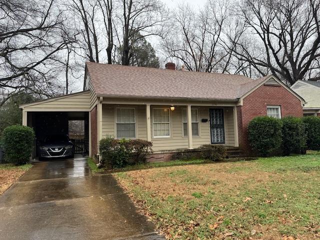 single story home with a front yard and a carport