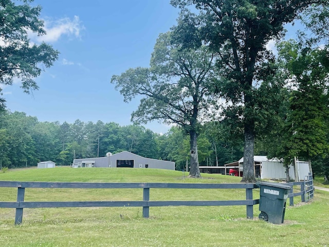 view of yard featuring an outdoor structure and a rural view