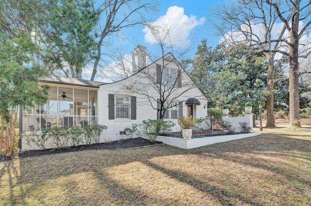 view of front of home with ceiling fan and a front yard