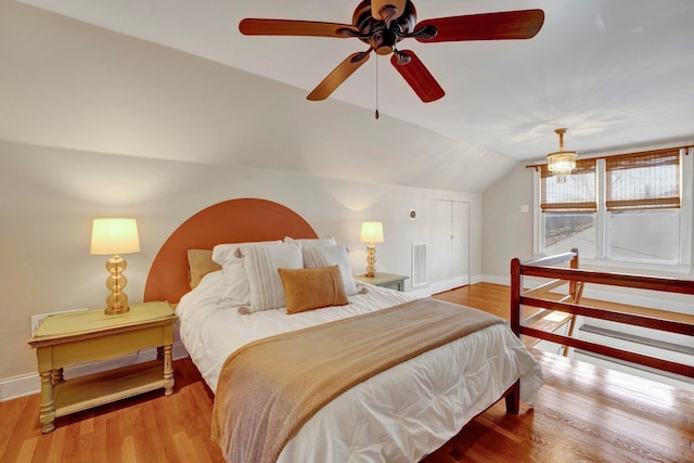 bedroom featuring hardwood / wood-style flooring, ceiling fan, and lofted ceiling