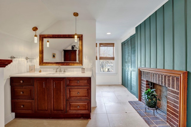 bathroom featuring vanity, tile patterned floors, and a fireplace