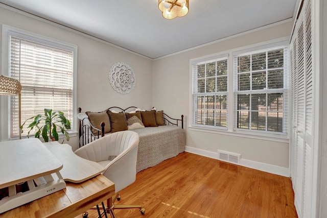 bedroom featuring crown molding and hardwood / wood-style flooring