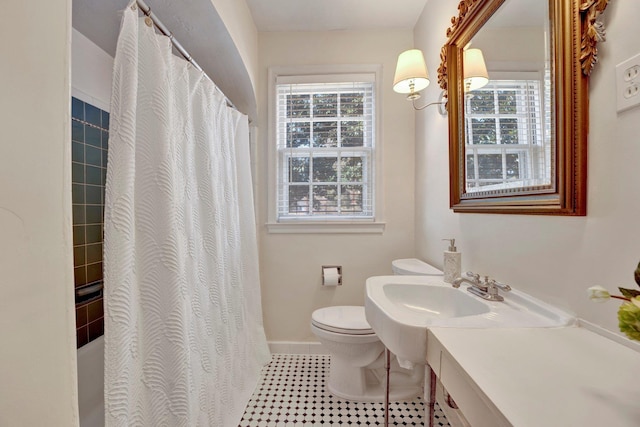 bathroom featuring tile patterned floors, toilet, a shower with shower curtain, and vanity