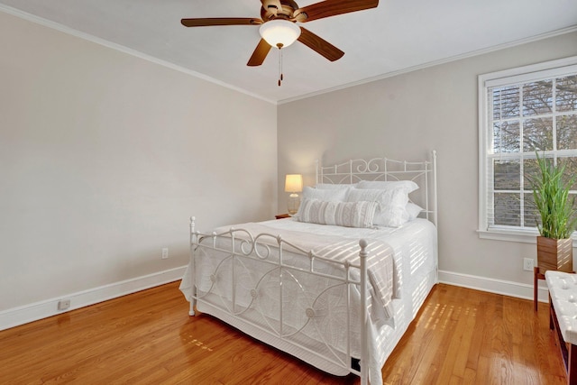 bedroom featuring ceiling fan, ornamental molding, and hardwood / wood-style floors