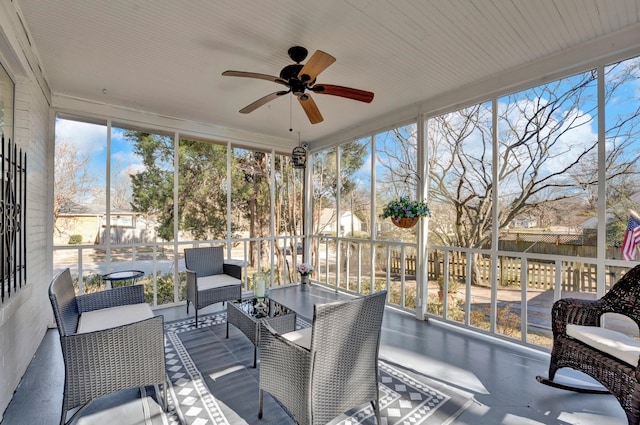 sunroom / solarium featuring ceiling fan