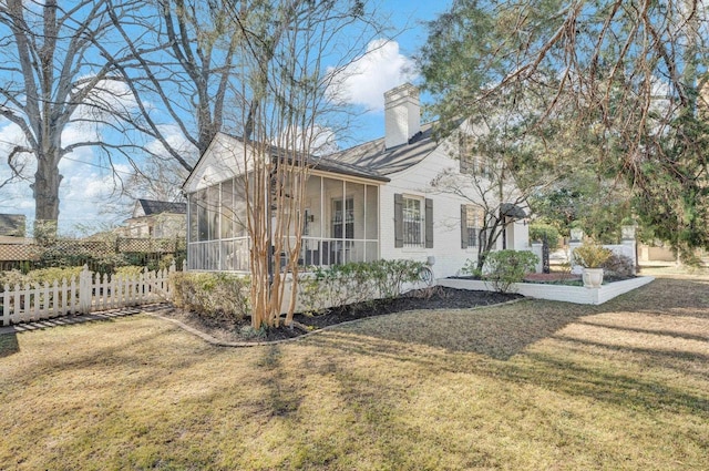 exterior space with a sunroom and a yard