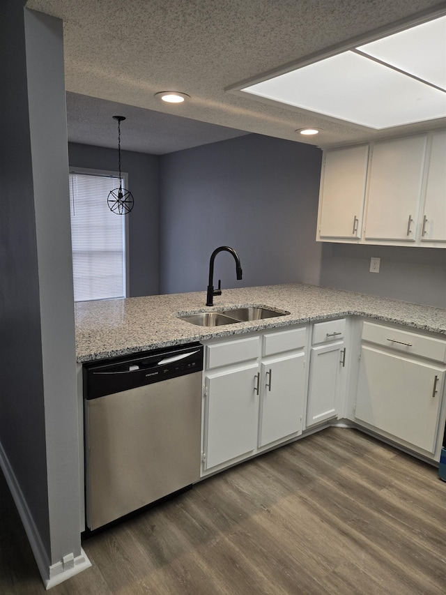 kitchen featuring sink, hanging light fixtures, dark hardwood / wood-style floors, dishwasher, and white cabinets