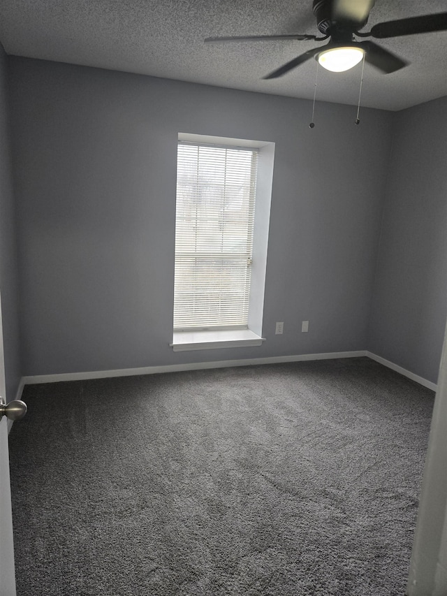 carpeted empty room featuring ceiling fan and a textured ceiling