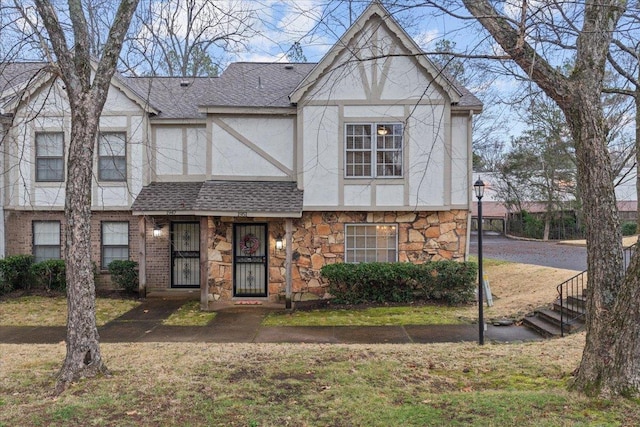 tudor home with a front yard