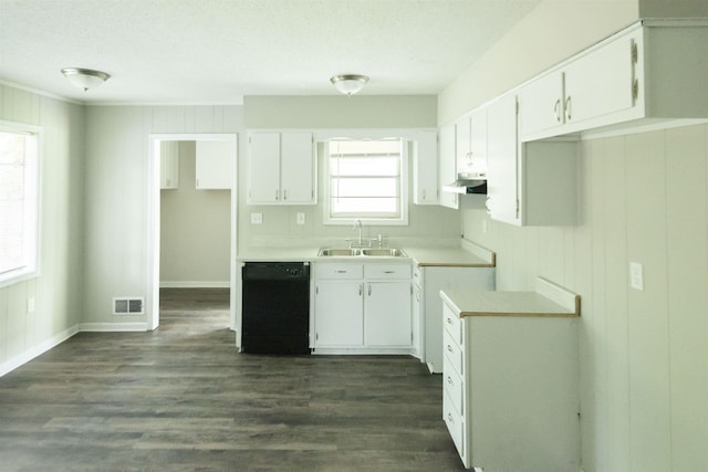 kitchen featuring black dishwasher, sink, and white cabinets