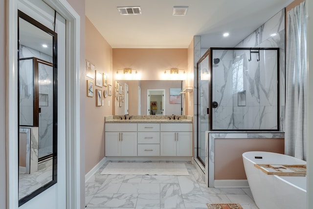 bathroom with vanity and independent shower and bath