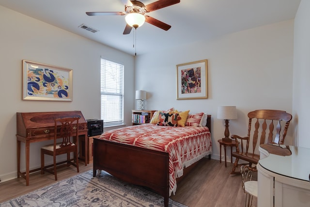 bedroom with ceiling fan and wood-type flooring