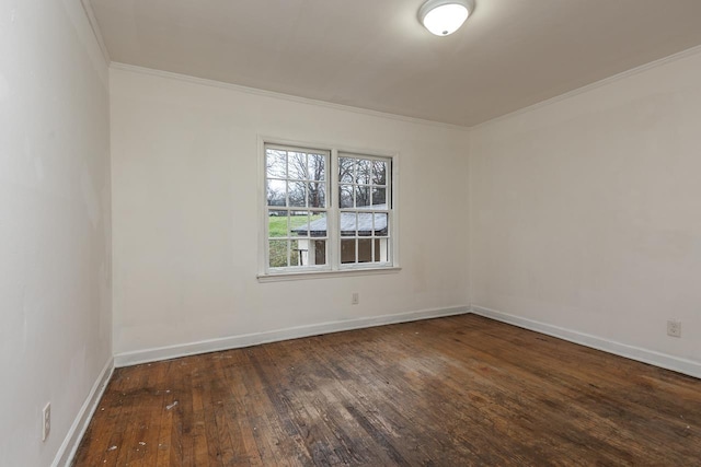 unfurnished room featuring ornamental molding and dark hardwood / wood-style flooring