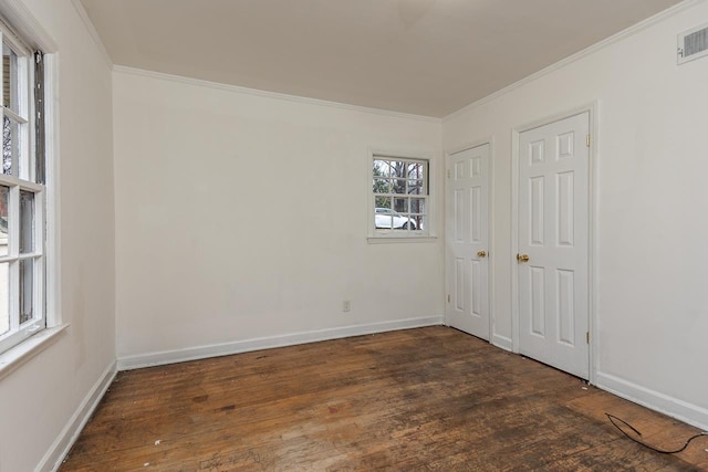 spare room featuring dark wood-type flooring and ornamental molding