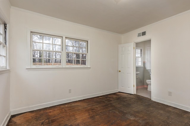 unfurnished room featuring crown molding, dark hardwood / wood-style floors, and a wealth of natural light