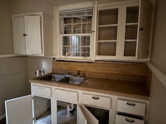 kitchen with white cabinetry, sink, and decorative backsplash