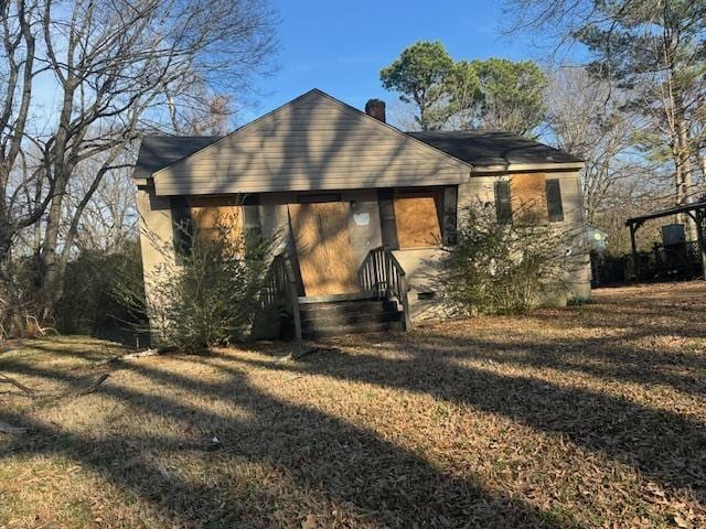 rear view of property featuring a yard