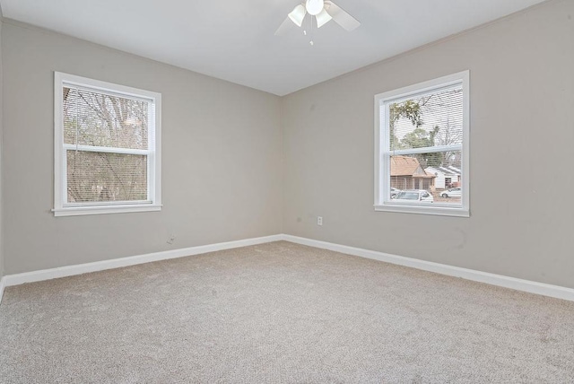 spare room featuring carpet flooring and ceiling fan