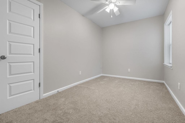 empty room featuring ceiling fan and carpet