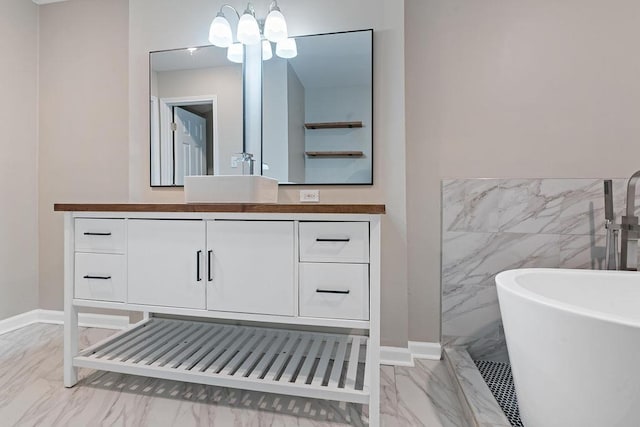 bathroom with vanity, a washtub, and tile walls