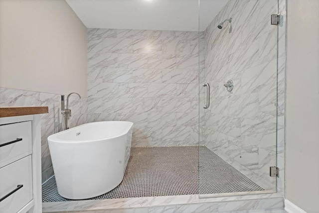 bathroom featuring shower with separate bathtub and tile walls