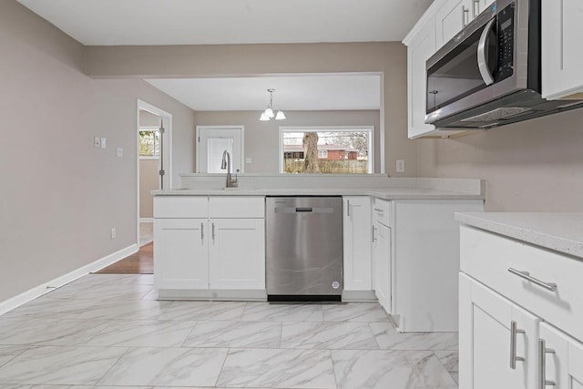 kitchen featuring sink, plenty of natural light, white cabinets, and appliances with stainless steel finishes