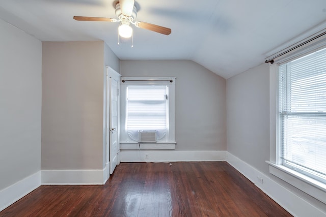 additional living space featuring cooling unit, plenty of natural light, and dark hardwood / wood-style floors