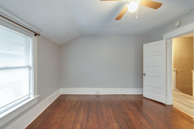 spare room featuring dark wood-type flooring, ceiling fan, and lofted ceiling